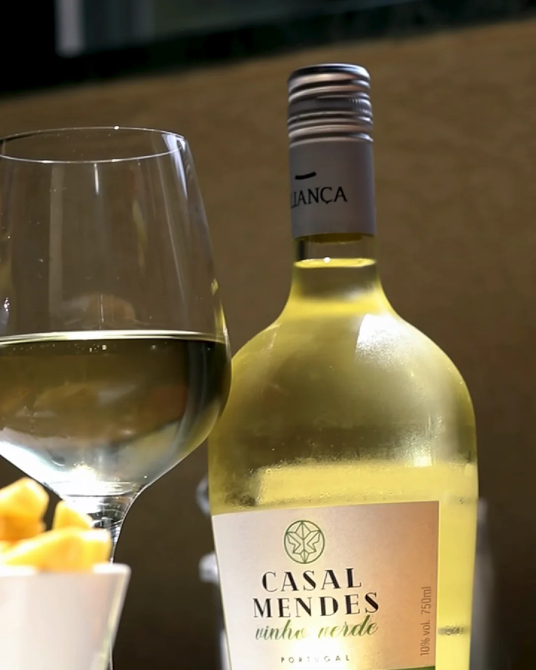 A bottle of Vinho Verde and a glass of white wine